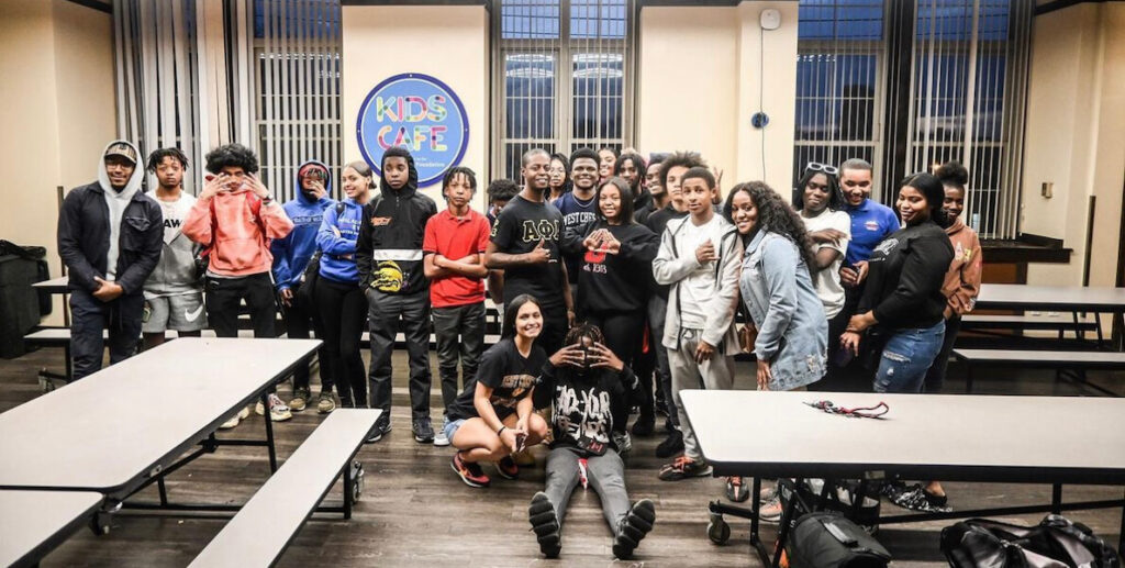 African American teens stand in a classroom.