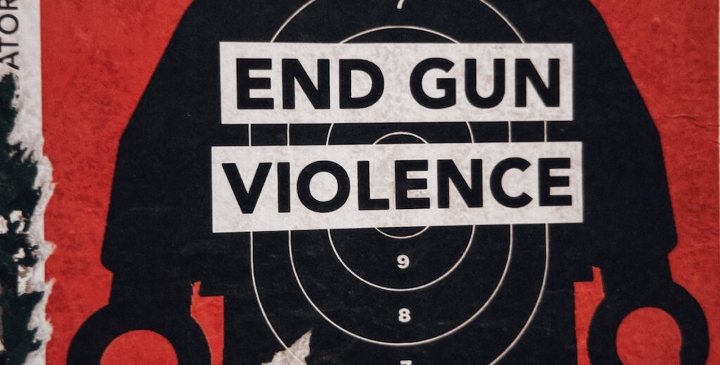 A mural depicts a black robot with a white target on his stomach and across the target, the words, "END GUN VIOLENCE."