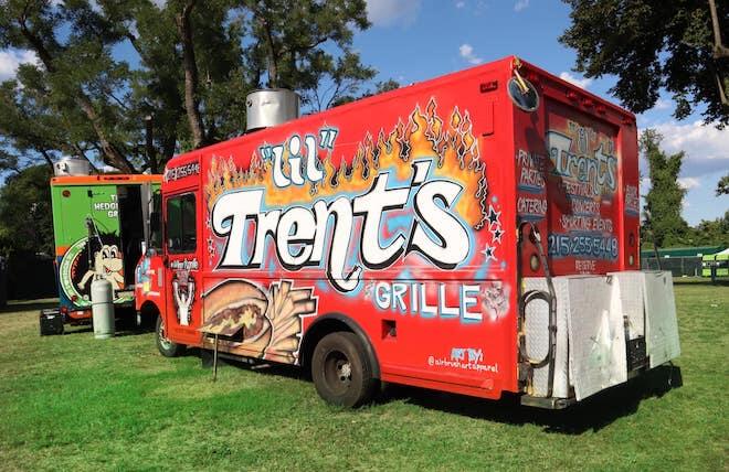 A red food truck belonging to Lil' Trent's Grille in Philly comes to The Elements of Hip Hop at Francisville Playground.
