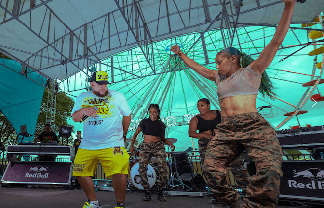 People dance hip hop onstage at the Oval XP. Hip Hop in the Park, presented by TAMERARTZ, returns for the genre's 50th anniversary.