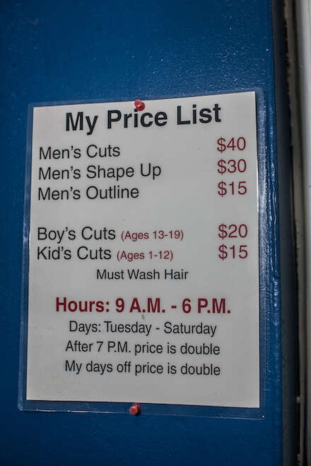 The price list at Mel's Barbershop offers prices for Men's cuts, shape up, outline, boy's and kid's cuts, and lists hours.