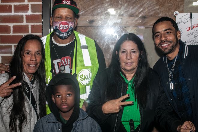 Posing at the Hug the Block finale event: Jamal Jordan (left, reflective vest and mask), family members and Cheri Honkala (green shirt, black jacket), co-founder of the Kensington Welfare Rights Union and co-founder and National Coordinator of the Poor People's Economic Human Rights Campaign 