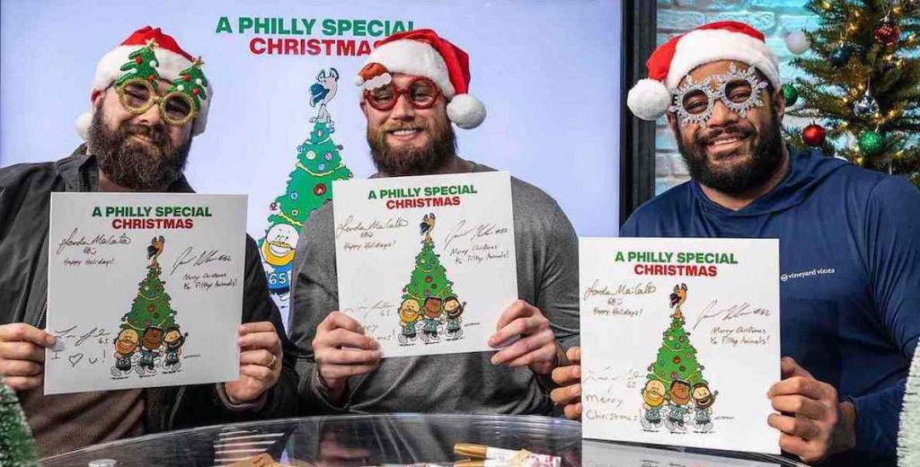 From left: Jason Kelce, Lane Johnson and Jordan Mailata hold the first A Philly Special Christmas album. Courtesy of the Philadelphia Eagles