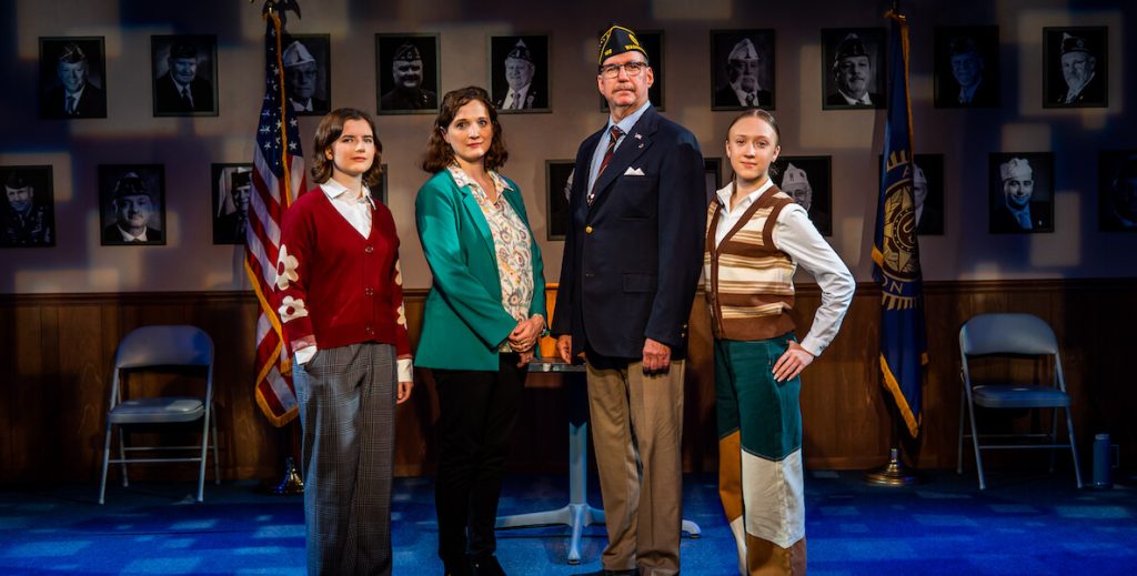 The cast of What the Constitution Means to Me — three White women and one White man in military uniform — stand onstage at the Arden Theatre.