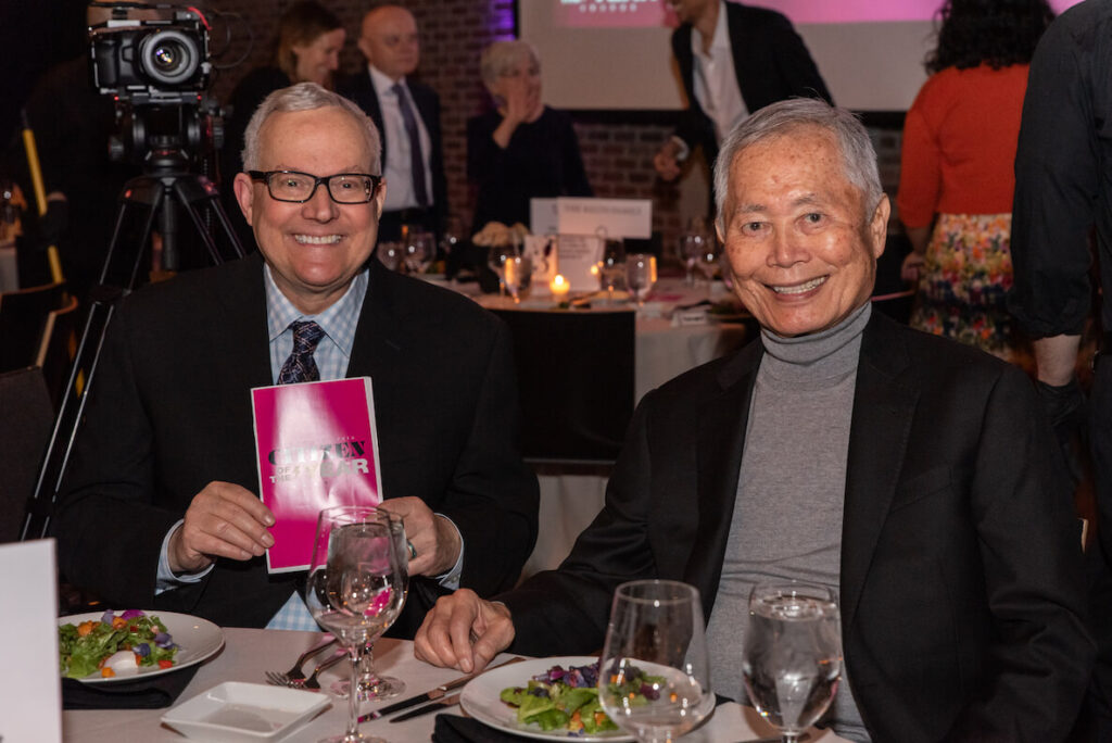 Brad (left) and George Takei at dinner.