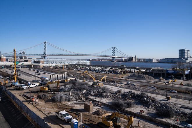 Current situation along I-95 near Penn's Landing. This depicts the I-95 CAP project construction, where a stretch of interstate has been demolished to make way for an overpass park. In the background: the Benjamin Franklin Bridge.