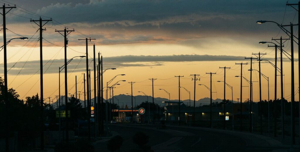 Sunset scene in El Paso, TX features many power lines and light poles.