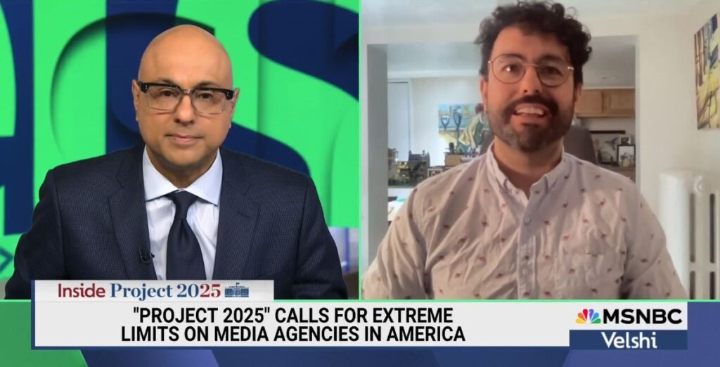On the left is MSNBC host Ali Velshi, a bald man with glasses in a suit and tie, and on the right is Vox Media's Zack Beauchamp, a bearded man with curly hair and wire framed glasses