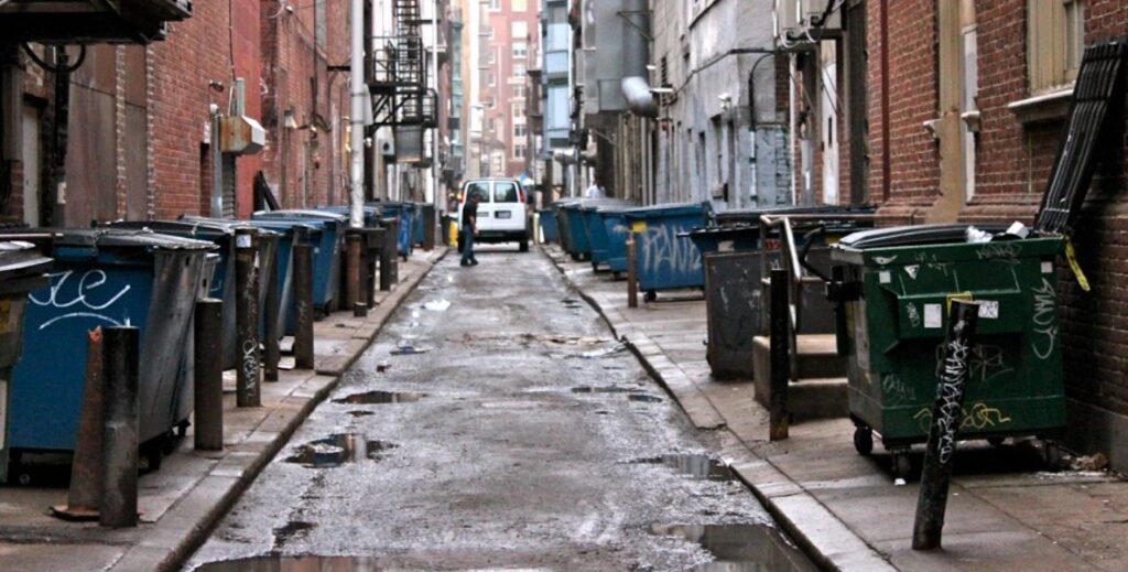 Dumpsters line an urban alley in Center City, Philadelphia.