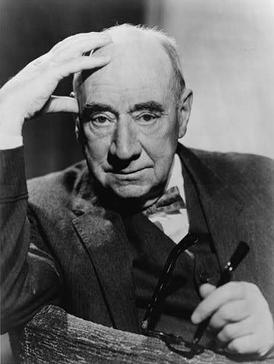 Attorney Joseph N. Welch. A black-and-white photographic portrait of a mostly bald White man wearing a dark suit and bowtie, leaning on one hand.