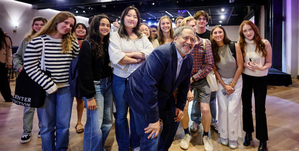 Author Michael Eric Dyson poses with students after the event.