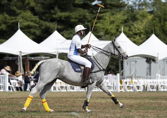 A former Work to Ride participant, a Black polo player, rides in the Philadelphia Polo Classic.