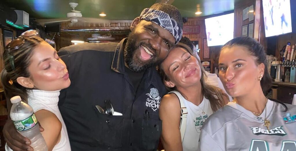 Reuben "Big Rube" Harley, chef at Pitchers Pub in Manayunk, with some Eagles fans.