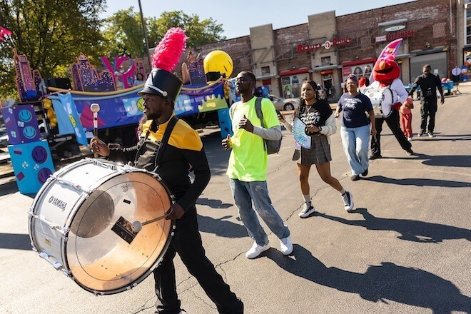 A drum line parades in a street of Philadelphia as part of the get out the vote effort of Joy to the Polls. Philly Elmo is there. 