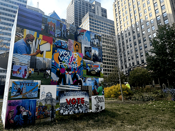 A collection of murals at City Hall as part of Mural Arts’ To the Polls show at Love Park. By Olivia Kram