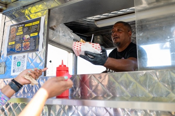 Ugly Plate's Chef Tez serves up chicken cheesesteaks for voters at Rumph Rec Center in North Philly. By Sabina Louise Pierce.