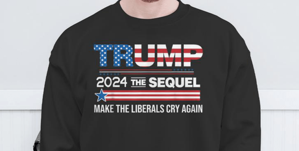 man wearing a t-shirt that reads "Trump 2024 The Sequel Make Liberals Cry Again" is an example of hate speech in the 2024 election