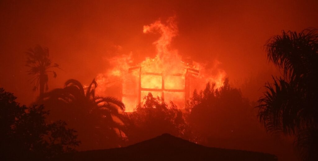 A house burns in the night in Palisades, California.