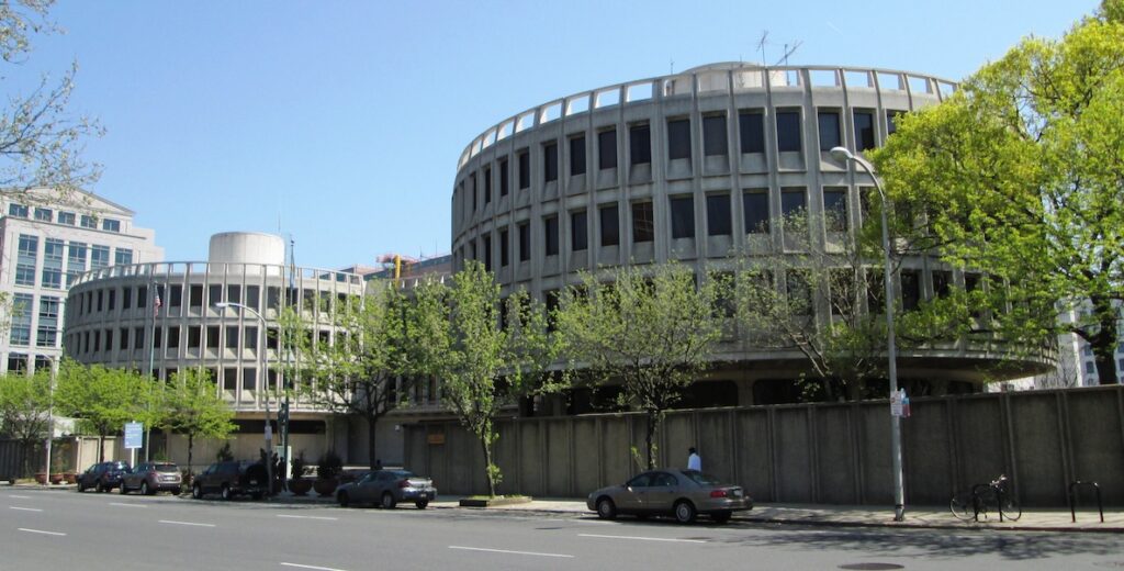 The Roundhouse, an Expressionist / Brutalist-style mid-century building features two round cement structures with rectangular windows connected by a squarer structure on Race Street in Philadelphia.