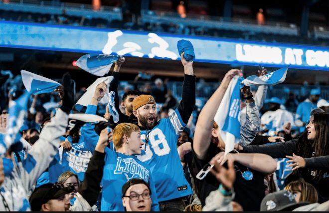 Detroit Lions fans watch an away game from their home stadium.