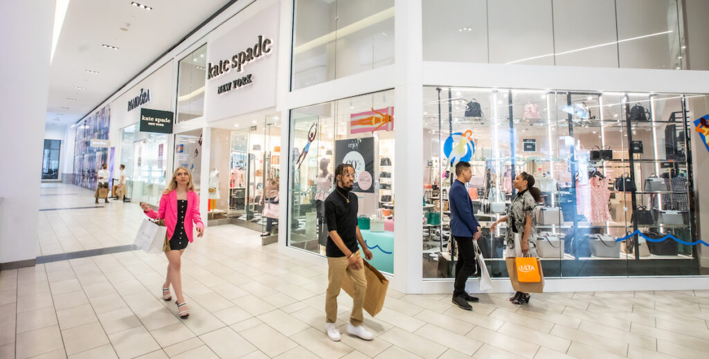 Shoppers carry shopping bags inside the Fashion District mall in Philadelphia.