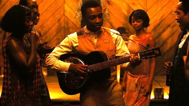 Actor Miles Caton plays guitar in <i>Sinners</i>.
