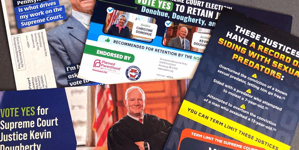 A pile of election mailings for various Pennsylvania candidates for judicial retention are laid out